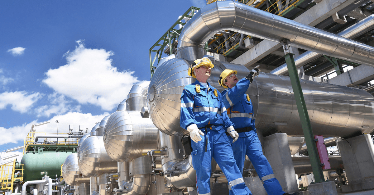 Two light industrial workers wearing blue suits