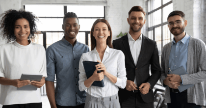 Three employees facing the camera, smiling