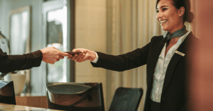 Receptionist handing a card to a customer