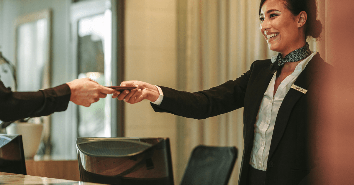 Receptionist handing a card to a customer