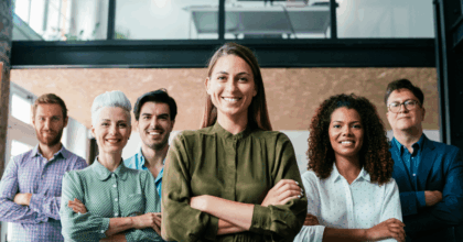 Six workers standing and smiling, arms crossed, one in front