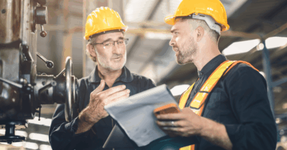 Two warehouse employees talking