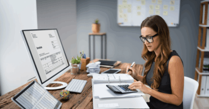 Employee working with calculator and computer