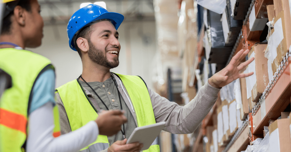 Warehouse workers looking at shelf