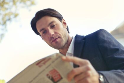 man looking down at paper
